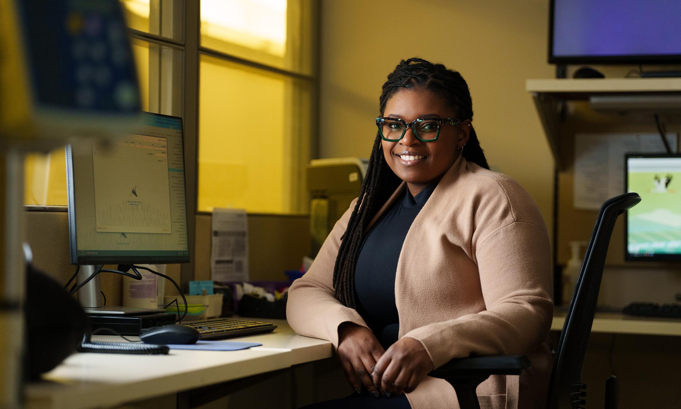 An image of Kala Seawright sitting at a desk